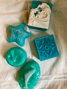 A collection of ocean-based soaps - wave soap, dolphin tail, seahorse, mermaid and starfish.